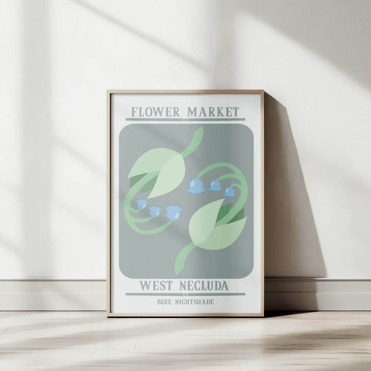 Blue Nightshade poster framed against a sunlit wall — bell flowers in soft blue and sage