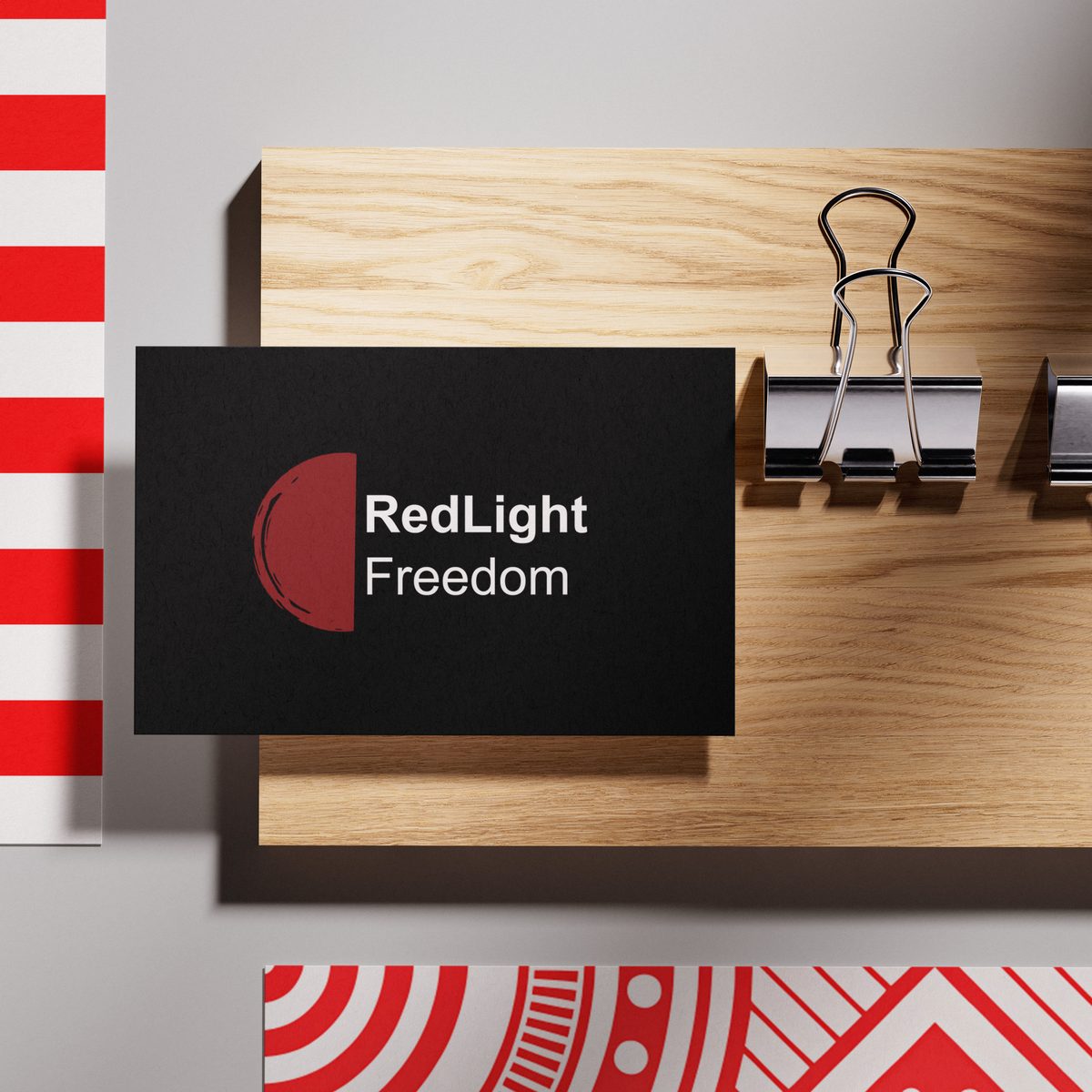 RedLight Freedom advocacy brand business card on wood